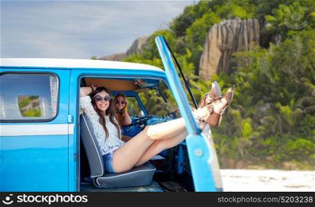 summer holidays, road trip, travel and people concept - smiling young hippie women resting in minivan car over tropical island beach background. happy hippie women in minivan car on island beach