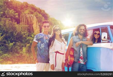 summer holidays, road trip, travel and people concept - smiling young hippie friends with guitar at minivan car over exotic island beach background. happy hippie friends at minivan car on island