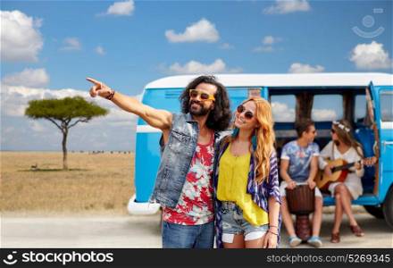 summer holidays, road trip, travel and people concept - smiling young hippie couple with friends in minivan car over african savannah background. happy hippie couples and minivan in africa