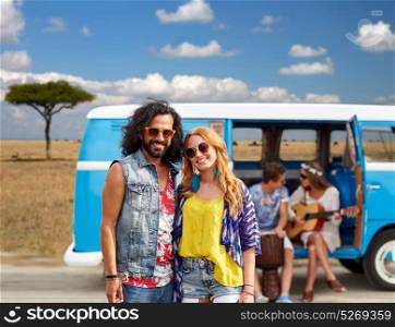 summer holidays, road trip, travel and people concept - smiling young hippie couple with friends in minivan car over african savannah background. happy hippie couples and minivan in africa