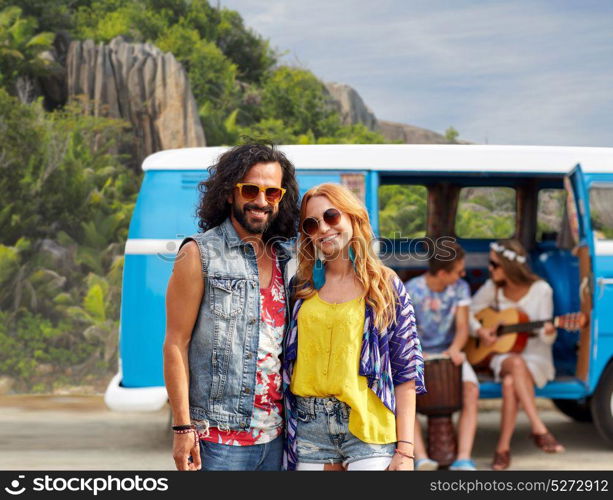 summer holidays, road trip, travel and people concept - smiling young hippie couple with friends in minivan car over exotic island background. happy hippie couples and minivan on island