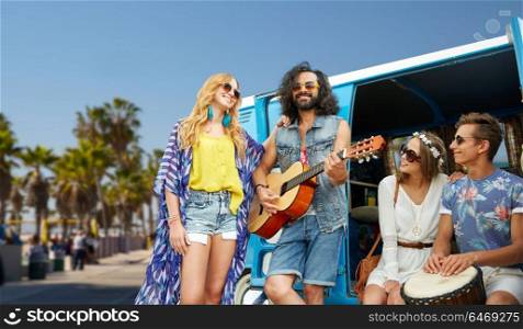 summer holidays, road trip, travel and vacation concept - happy young hippie friends having fun and playing music over minivan car and venice beach in los angeles background. hippie friends playing music over minivan in la