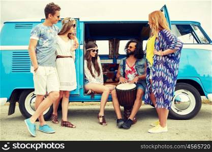 summer holidays, road trip, vacation, travel and people concept - happy young hippie friends with tom-tom drum playing music over minivan car