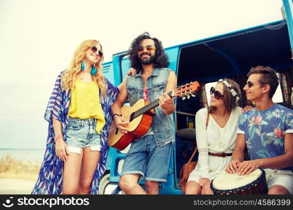 summer holidays, road trip, vacation, travel and people concept - happy young hippie friends having fun and playing music over minivan car