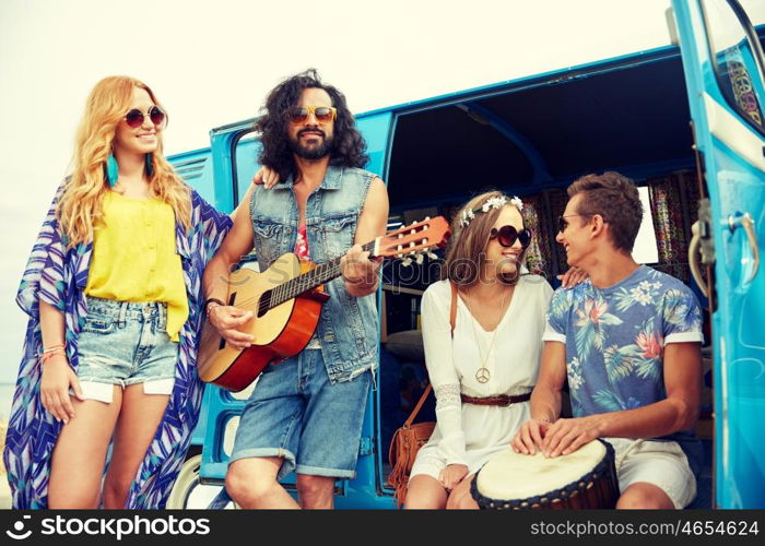 summer holidays, road trip, vacation, travel and people concept - happy young hippie friends with guitar and tom-tom drum playing music over minivan car