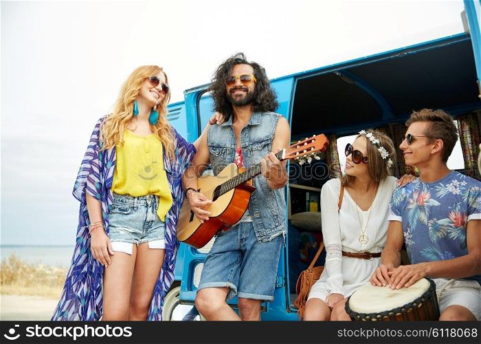 summer holidays, road trip, vacation, travel and people concept - happy young hippie friends having fun and playing music over minivan car