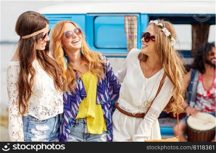 summer holidays, road trip, vacation, travel and people concept - happy young hippie friends having fun and talking over minivan car
