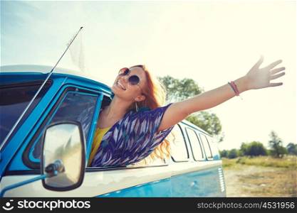 summer holidays, road trip, vacation, travel and people concept - smiling young hippie woman driving minivan car and waving hand