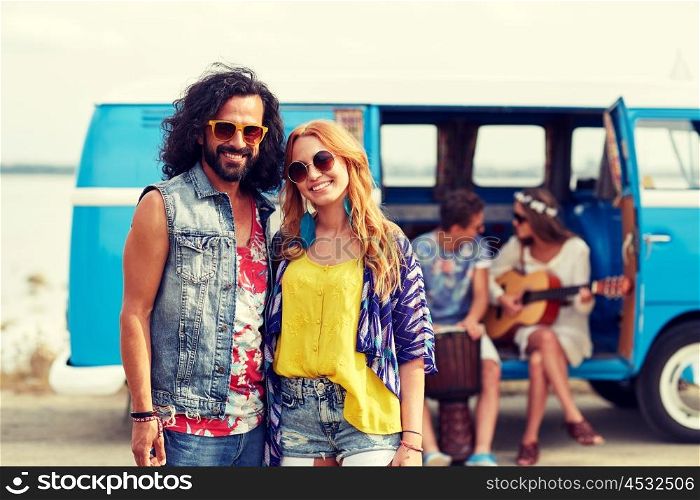 summer holidays, road trip, vacation, travel and people concept - smiling young hippie couple with friends over minivan car