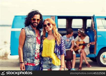 summer holidays, road trip, vacation, travel and people concept - smiling young hippie couple with friends over minivan car