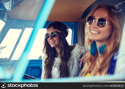 summer holidays, road trip, vacation, travel and people concept - smiling young hippie women driving in minivan car