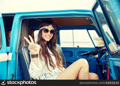 summer holidays, road trip, vacation, travel and people concept - smiling young hippie woman showing peace gesture in minivan car