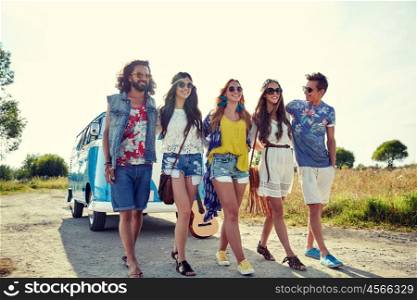 summer holidays, road trip, vacation, travel and people concept - smiling young hippie friends walking over minivan car