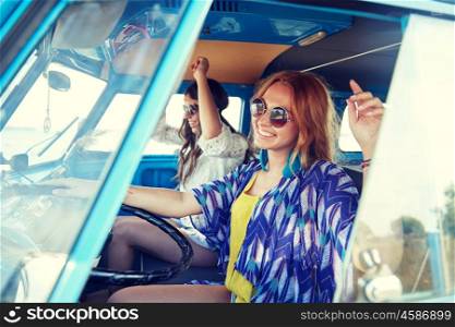 summer holidays, road trip, vacation, travel and people concept - smiling young hippie women driving and having fun in minivan car