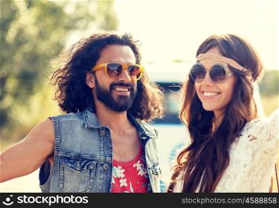 summer holidays, road trip, vacation, travel and people concept - smiling young hippie couple over minivan car