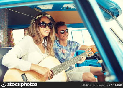 summer holidays, road trip, vacation, travel and people concept - smiling young hippie couple with guitar playing music in minivan car