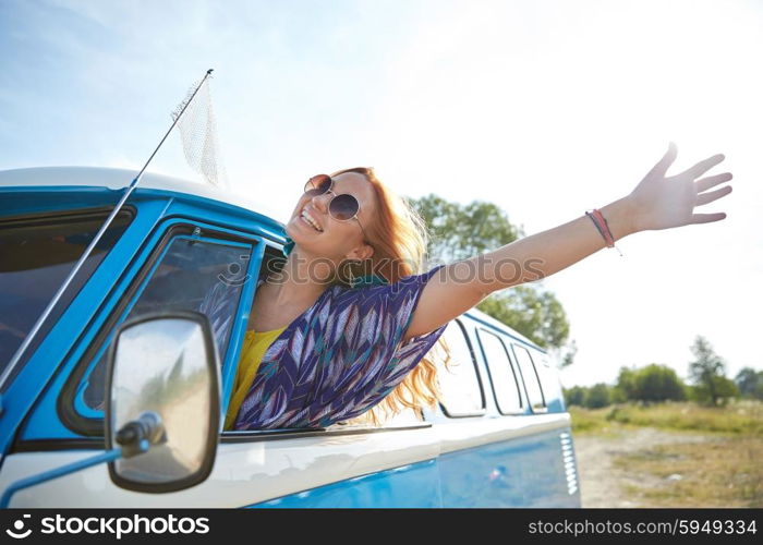 summer holidays, road trip, vacation, travel and people concept - smiling young hippie woman driving minivan car and waving hand