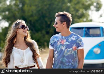 summer holidays, road trip, vacation, travel and people concept - smiling young hippie couple talking over minivan car