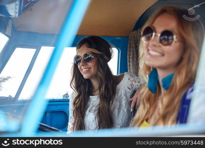 summer holidays, road trip, vacation, travel and people concept - smiling young hippie women driving in minivan car