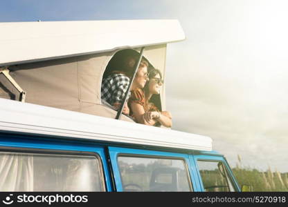 Summer holidays, road trip, vacation, travel and people concept - smiling young hippie women in car