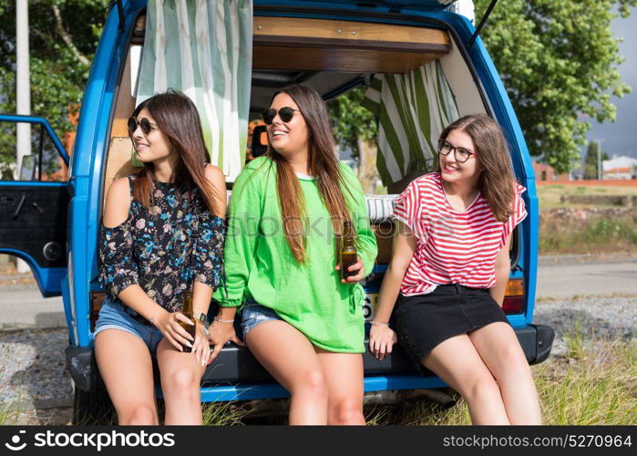 Summer holidays, road trip, vacation, travel and people concept - smiling young hippie women in car