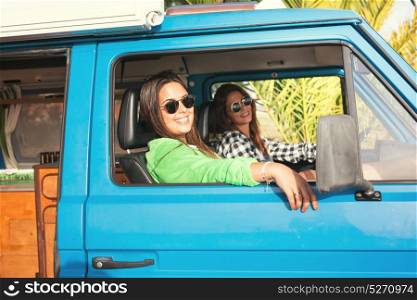 Summer holidays, road trip, vacation, travel and people concept - smiling young hippie women in car