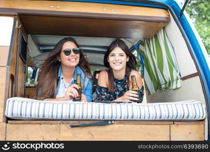 Summer holidays, road trip, vacation, travel and people concept - smiling young hippie women in car