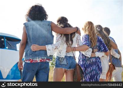 summer holidays, road trip, vacation, travel and people concept - young hippie friends hugging over minivan car from back