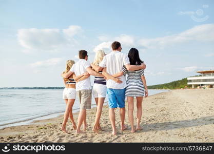 summer, holidays, sea, tourism and people concept - group of smiling friends hugging and walking on beach from back