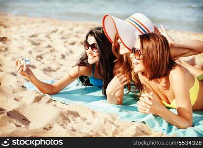 summer holidays, technology and beach concept - girls making self portrait on the beach