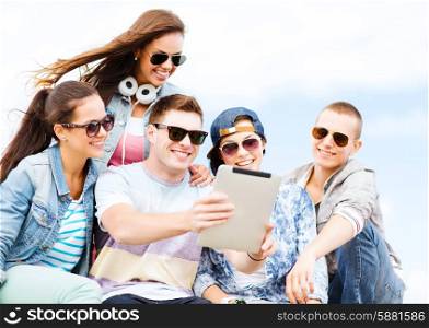 summer holidays, teenage and technology concept - group of teenagers taking picture with tablet pc