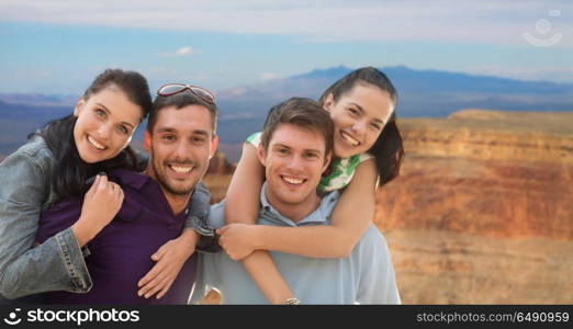 summer holidays, tourism and travel concept - group of happy friends or couples over grand canyon national park background. group of happy friends. group of happy friends