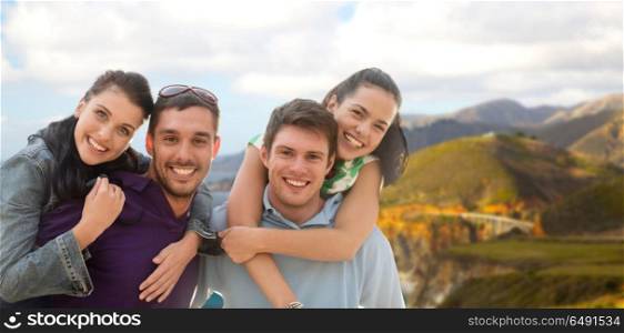 summer holidays, tourism and travel concept - group of happy friends or couples over big sur coast of california background. group of happy friends. group of happy friends