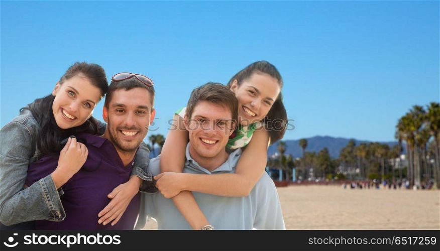 summer holidays, tourism and travel concept - group of happy friends or couples over venice beach background in california. group of happy friends. group of happy friends