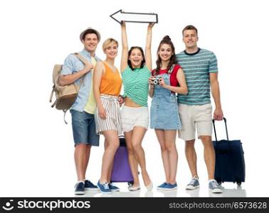 summer holidays, tourism and vacation concept - group of happy friends with travel bags, camera and arrow over white background. friends with travel bags, camera and arrow
