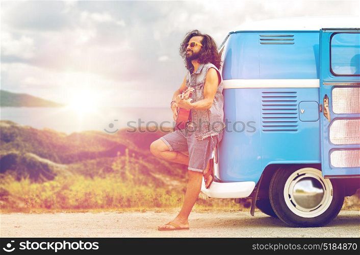 summer holidays, travel, music and people concept - young hippie man playing guitar and singing at minivan car over island and sea background. hippie man playing guitar at minivan car on island