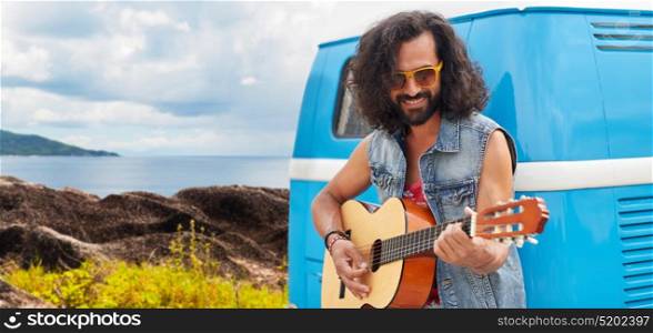 summer holidays, travel, music and people concept - young hippie man playing guitar at minivan car over island and sea background. hippie man playing guitar at minivan car on island