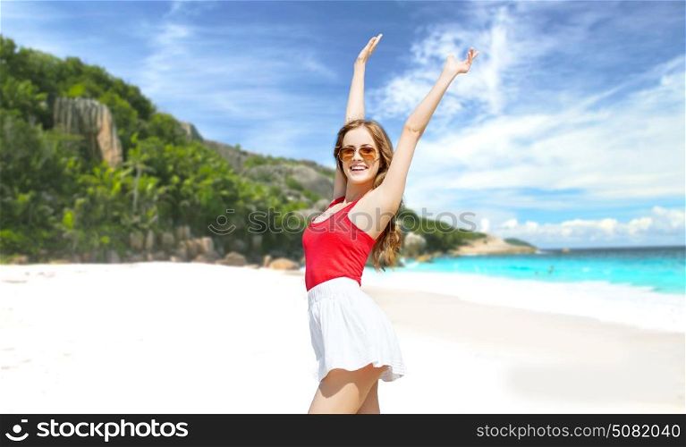 summer holidays, travel, people and vacation concept - happy smiling young woman in sunglasses over exotic tropical beach background. happy young woman in sunglasses on summer beach