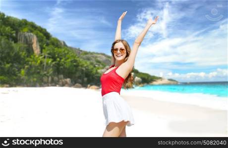 summer holidays, travel, people and vacation concept - happy smiling young woman in sunglasses over exotic tropical beach background. happy young woman in sunglasses on summer beach