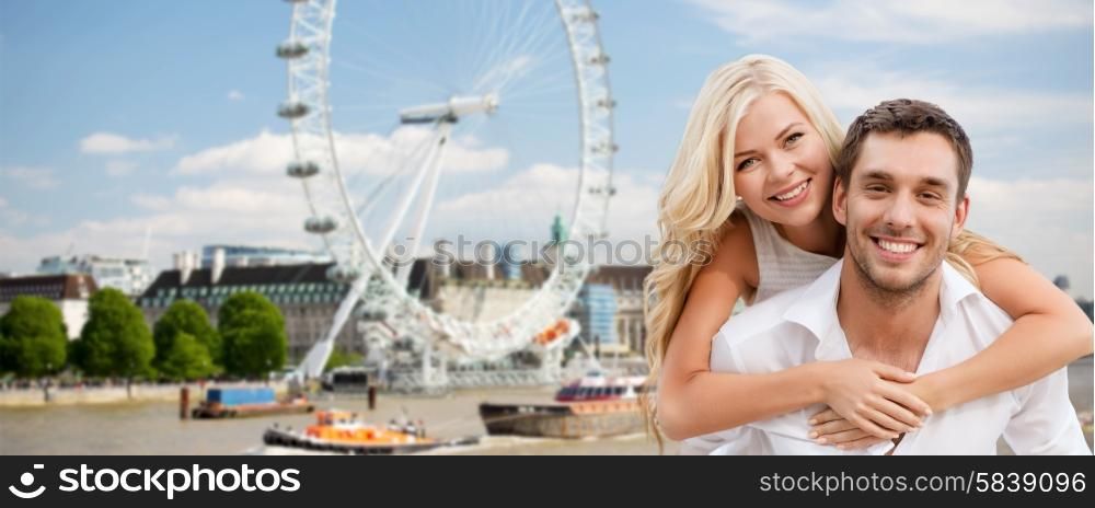 summer holidays, travel, tourism, people and dating concept - happy couple hugging over london ferry wheel background