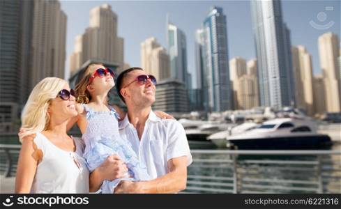 summer holidays, travel, tourism, vacation and people concept - happy family over dubai city street background