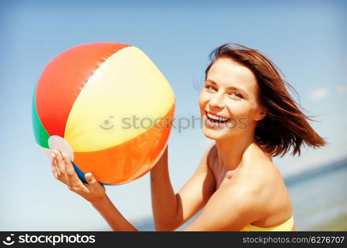 summer holidays, vacation and beach activities concept - girl in bikini playing ball on the beach