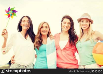 summer holidays, vacation and beach activities concept - smiling girls having fun on the beach