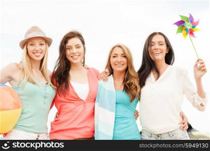 summer holidays, vacation and beach activities concept - smiling girls having fun on the beach