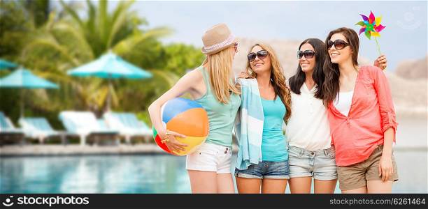 summer holidays, vacation and beach activities concept - smiling girls in shades having fun on the beach
