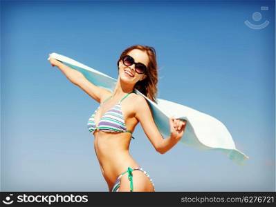 summer holidays, vacation and beach concept - girl in bikini and shades on the beach