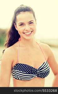 summer holidays, vacation and beach concept - girl in bikini posing on the beach