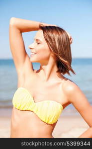 summer holidays, vacation and beach concept - girl posing in bikini on the beach