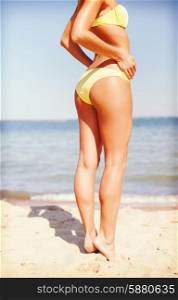 summer holidays, vacation and beach concept - girl posing in bikini on the beach
