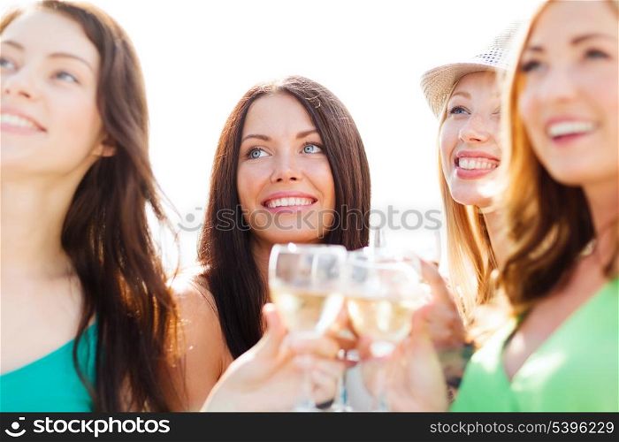 summer holidays, vacation and celebration - girls with champagne glasses